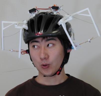robot on bike helmet, pulling wearer's ears